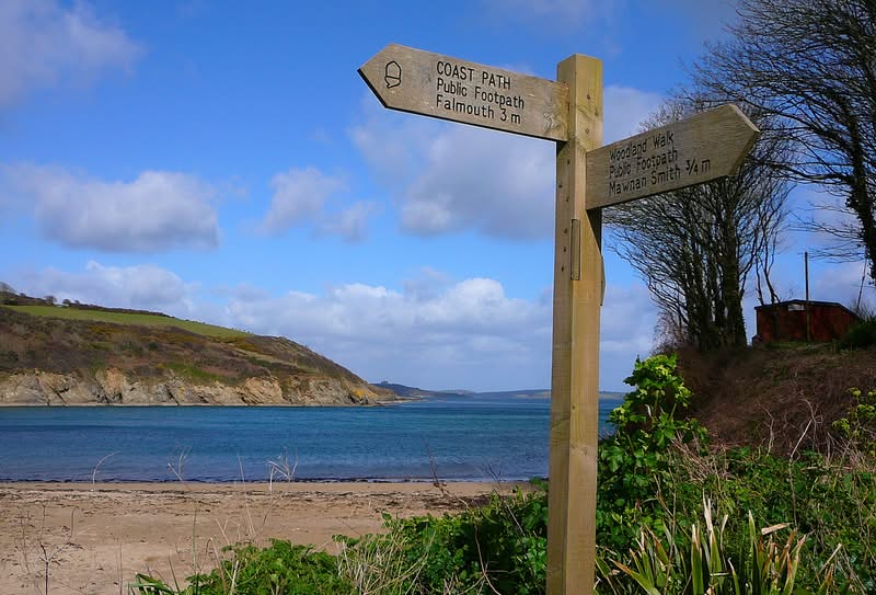 Signpost on a beach along the South West Coast Path, Cornwall