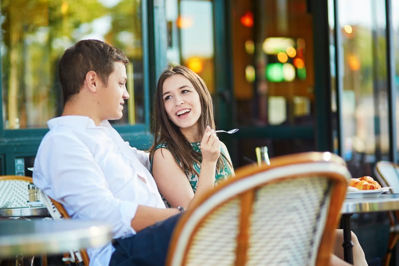 Couples chatting outside a cafe