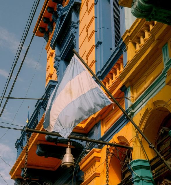 a Building with a Flag Hanging From Its Side in Buenos Aires, Argentina.