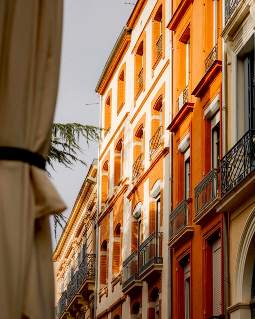 Colorful Buildings Line a European Street in Toulouse, France.