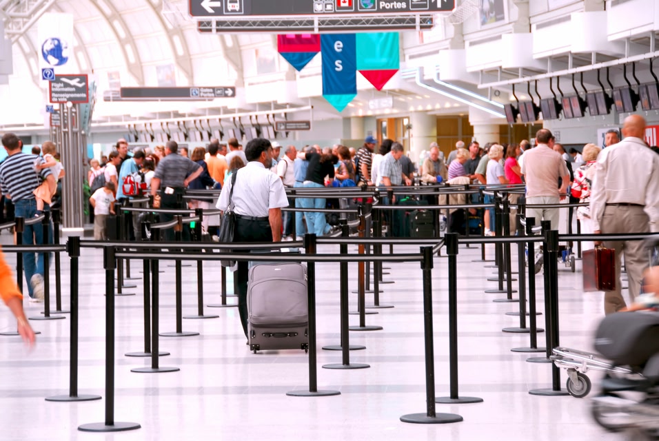 Travellers lining up at an airport
