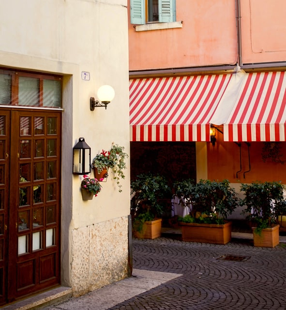 a Building with a Red and White Striped Awning in Bologna, Italy.