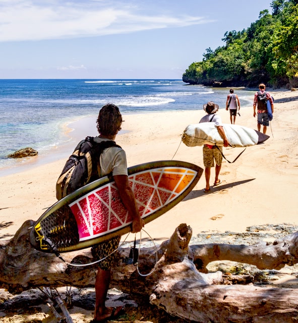 Davao beach with men with surfboards in Davao, Philippines.