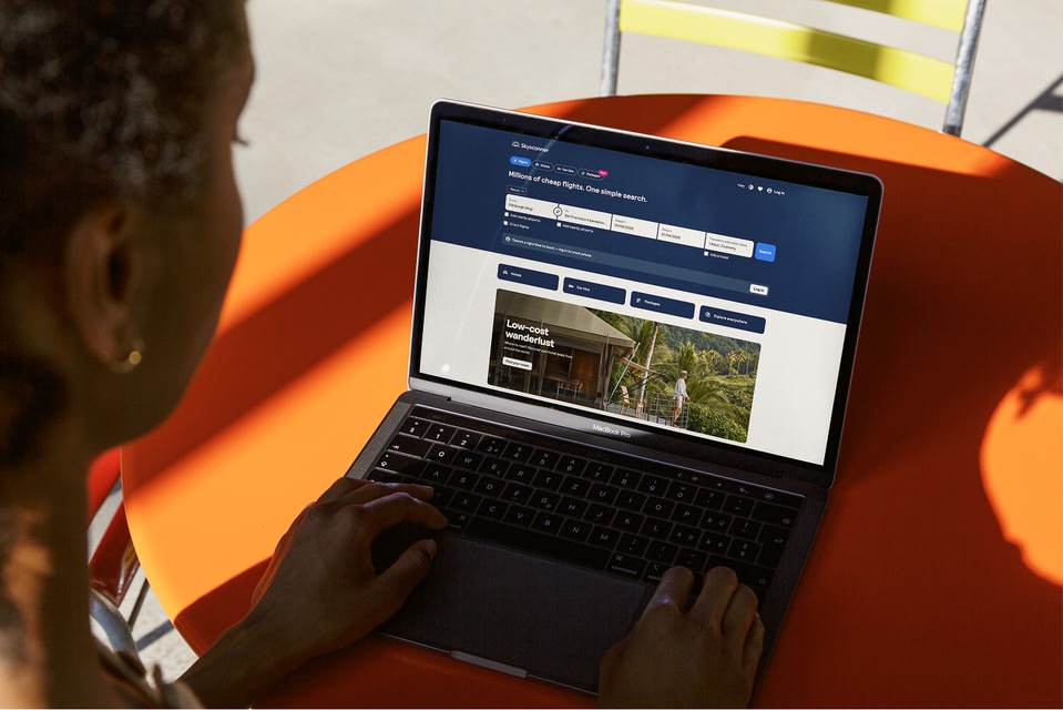 Person looking at Skyscanner website on laptop