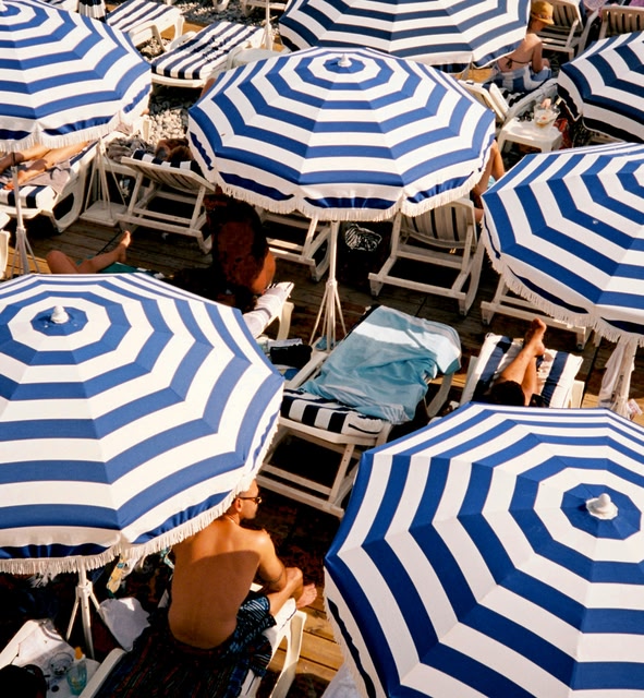 People Sitting under Umbrellas in Nice, France.