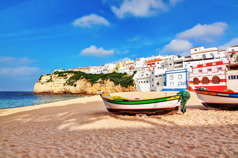Colourful boats on a beach in Portugal's Algarve region.