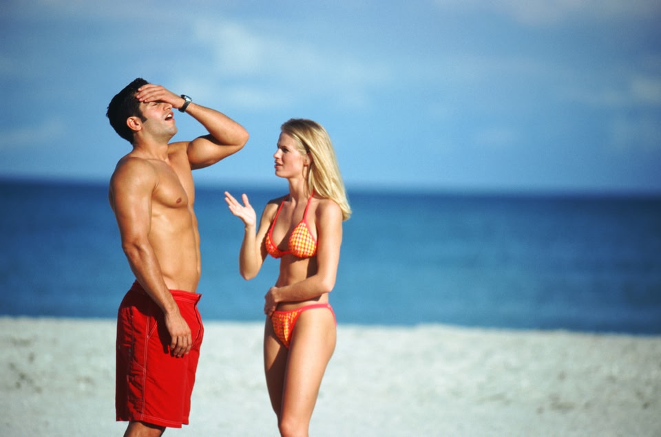 Couple in bathing suits arguing - 10 most common holiday arguments couples have