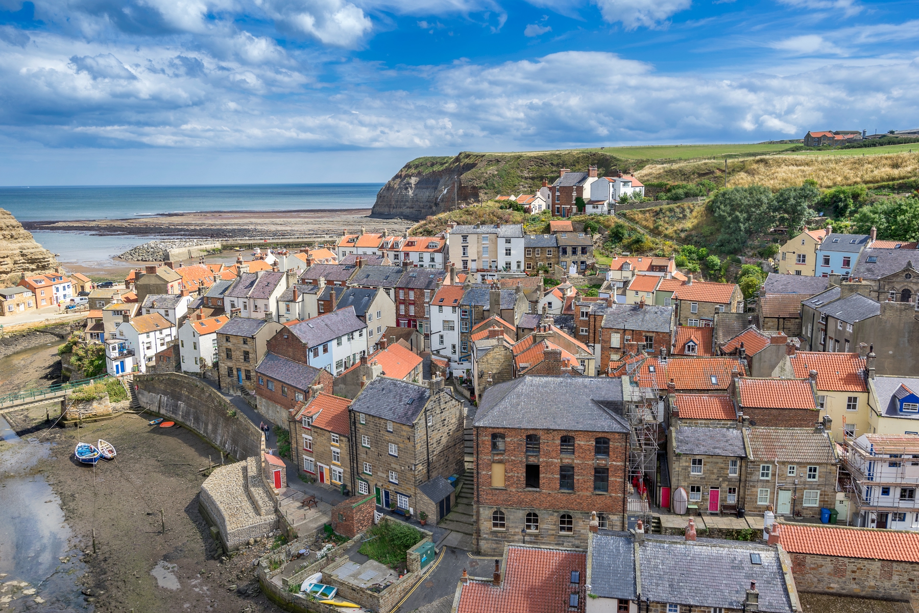 Aerial view of Staithes ith its small sandy fishing beach , one of the best places to visit in Yorkshire