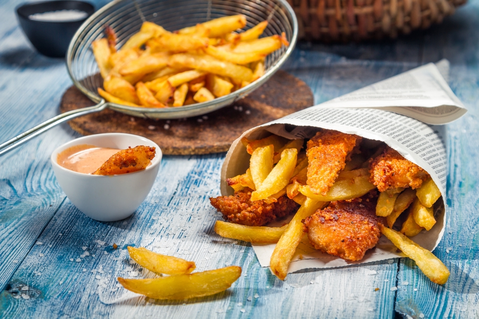 Fish and chips wrapped in newspaper.