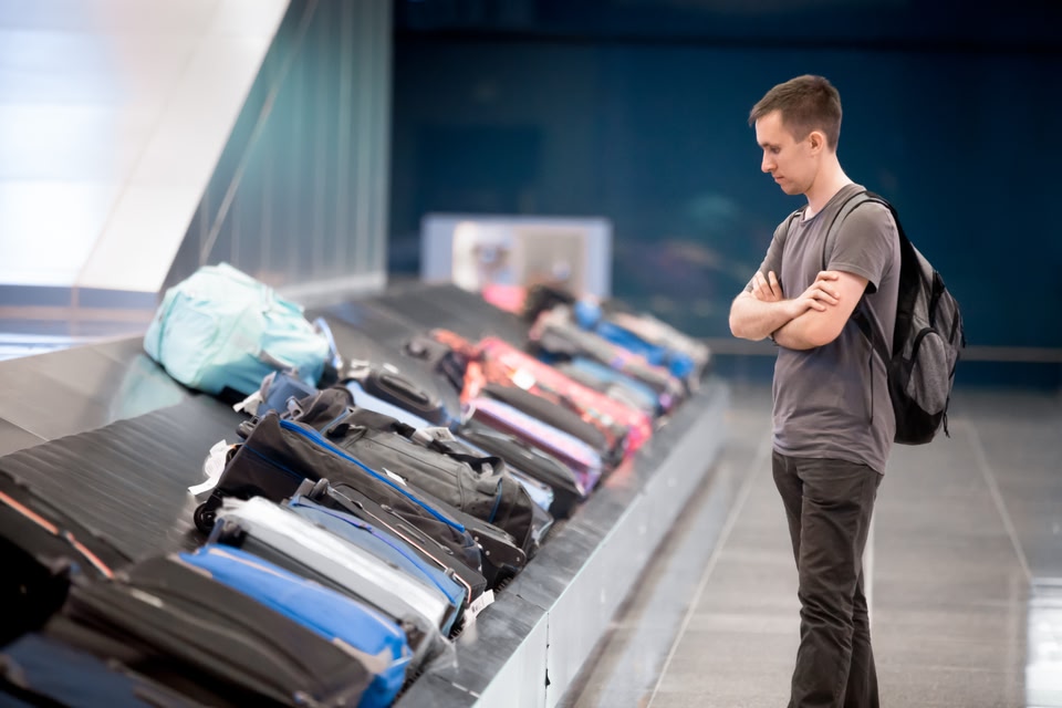 Man waiting for his luggage at the airport