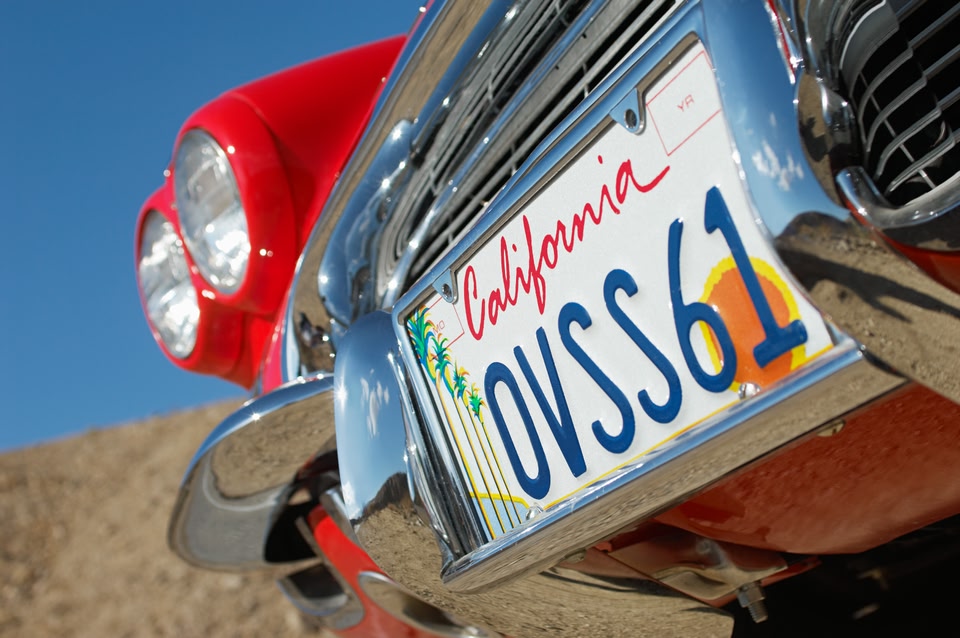 California license plate on a red car