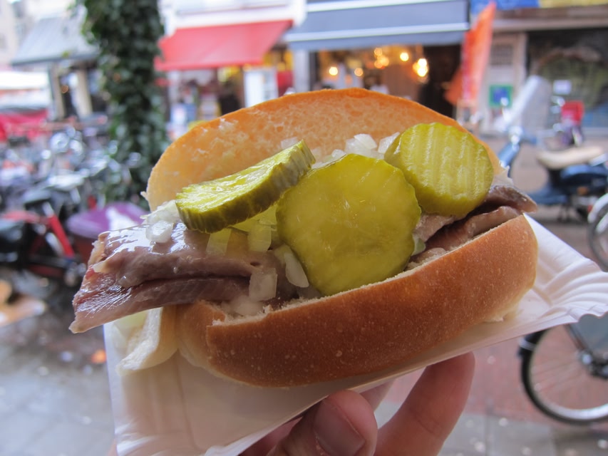 Street food in Amsterdam: herring on a bread roll with onions and gherkins.