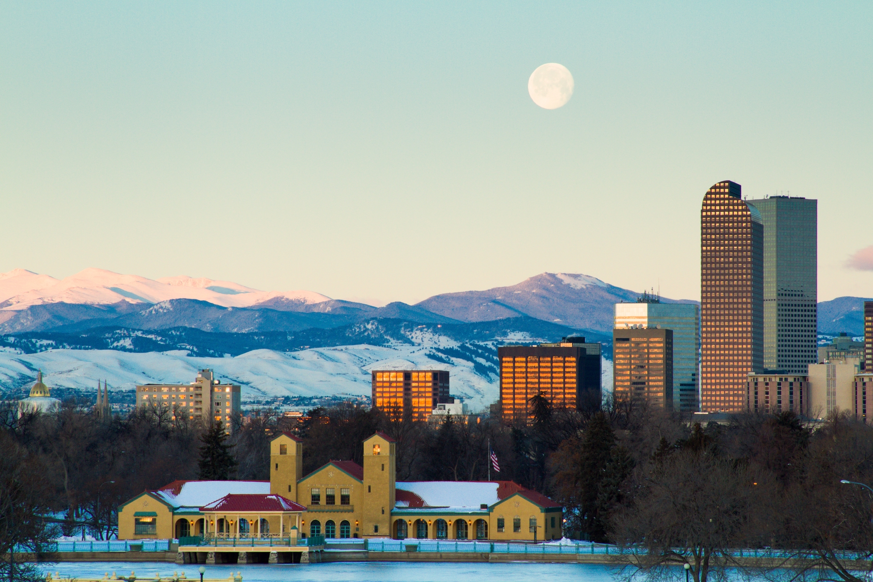 Winter view of Denver with a nearly full moon in the sky