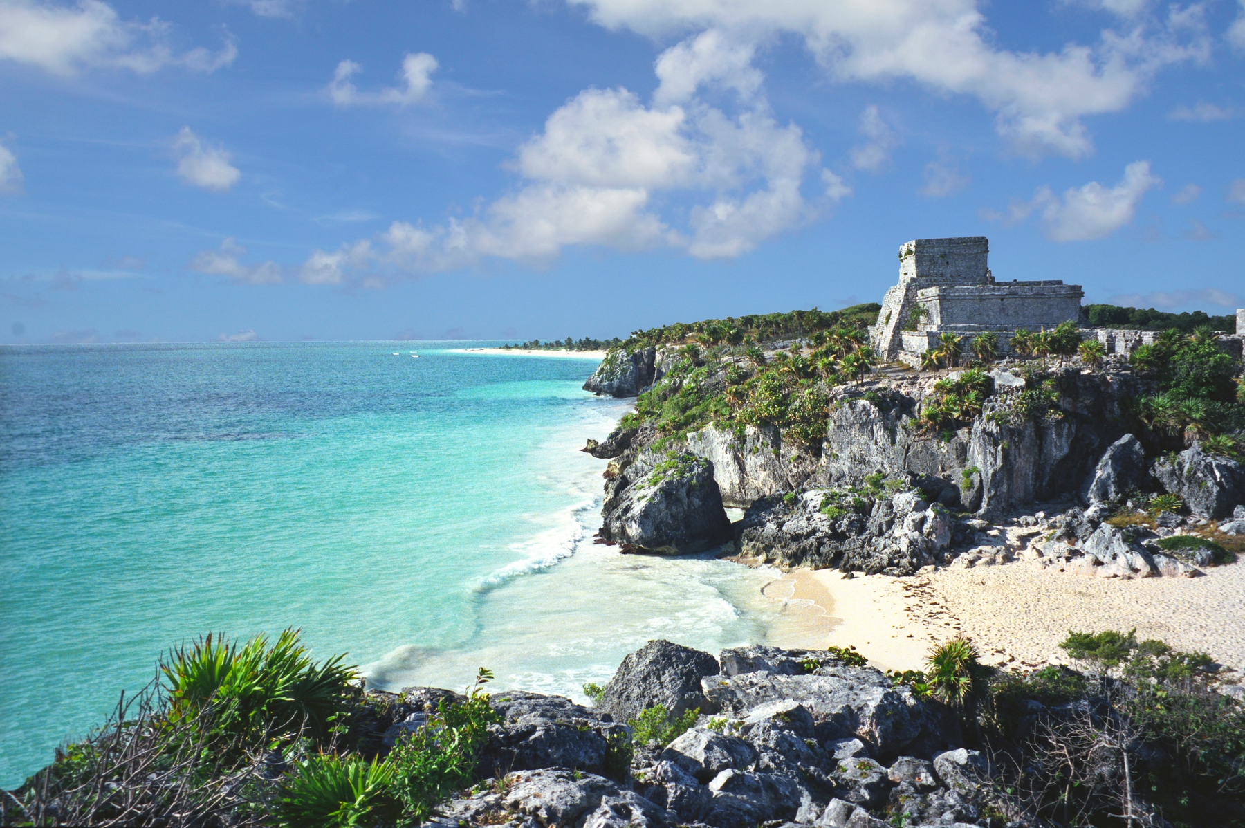 Mayan ruins overlooking the turquoise waters and a quiet beach in Tulum, Mexico