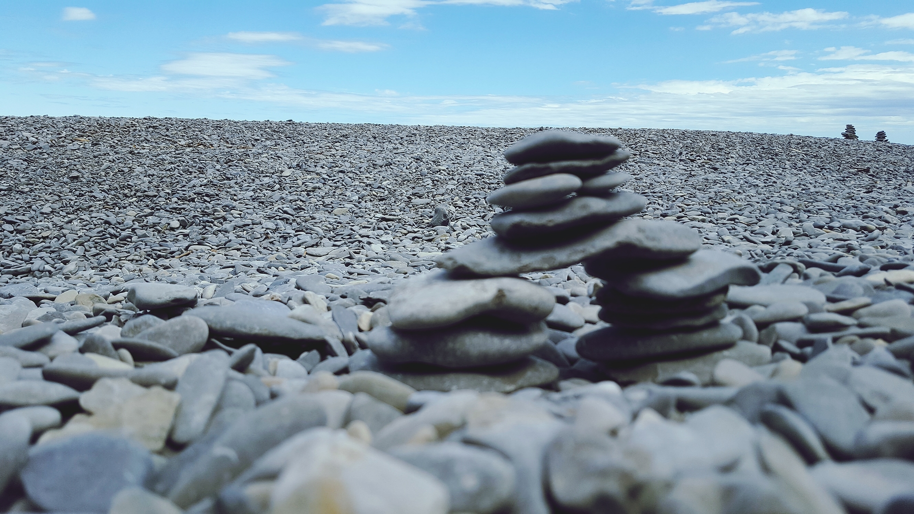 rocks stacked up along the shore in Forillon National Park, a great spot for camping in Quebec