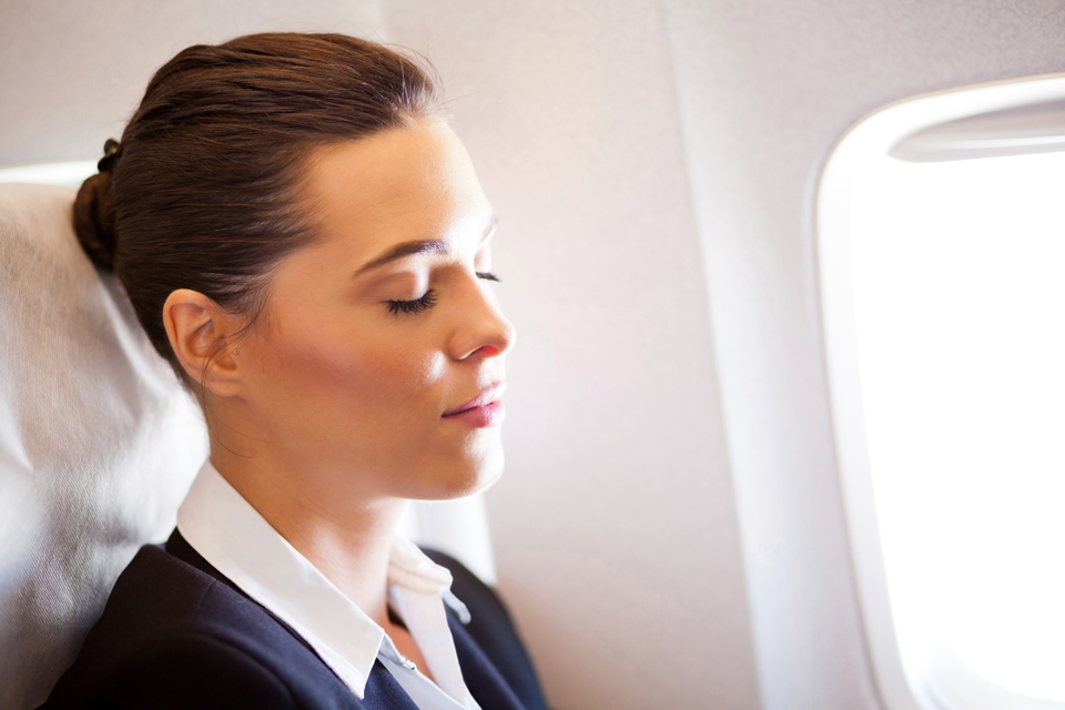 Kvinna vid fönsterplats ombord på flygplan
