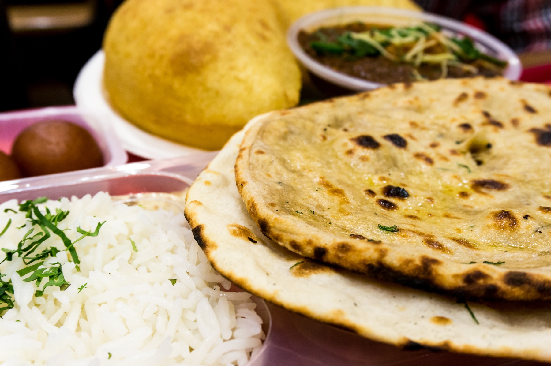 a plate of dahl with naan and rice in New Delhi
