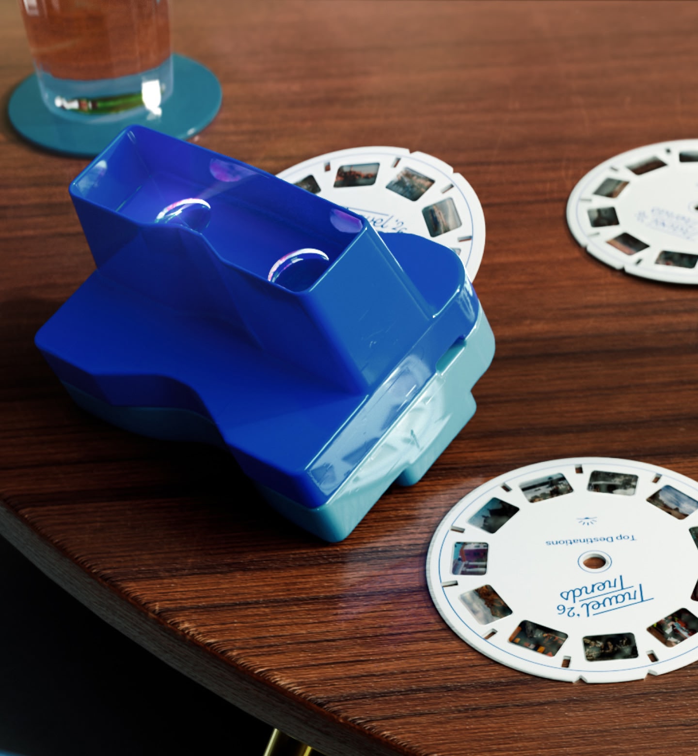 Blue plastic viewfinder toy with various reels nearby, showing trending destinations for 2026