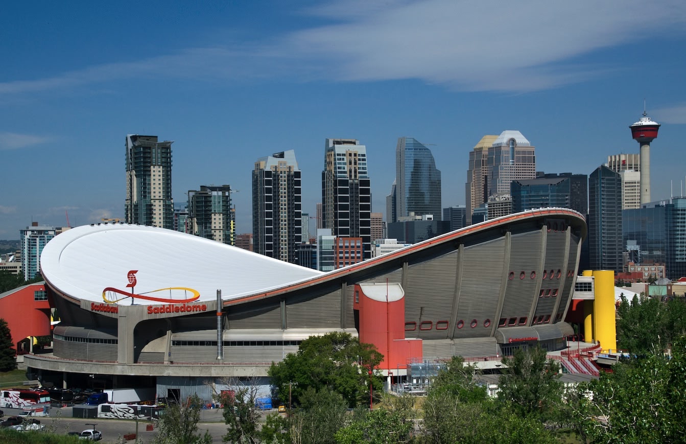 Calgary Saddledome and city skyline on a clear day.