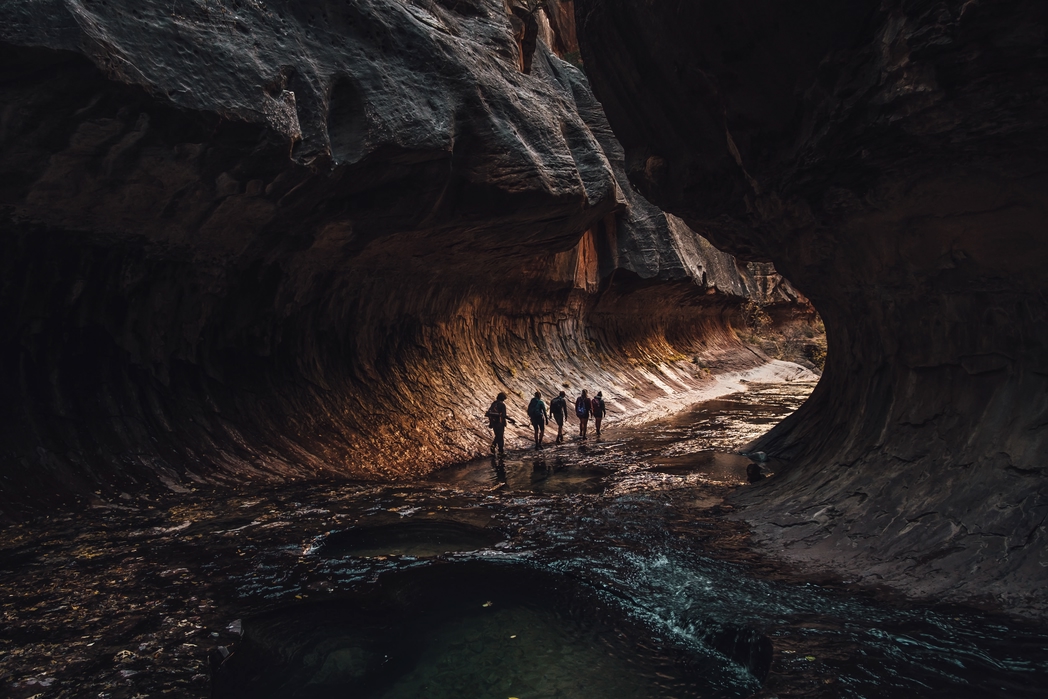 Travellers exploring a cave - 7 costly mistakes that will squeeze your holiday budget