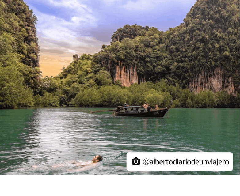 Tranquil Thai lake scene: A man leisurely swimming, a longboat gracefully afloat, and a lush forest backdrop, all set against the soothing green waters.