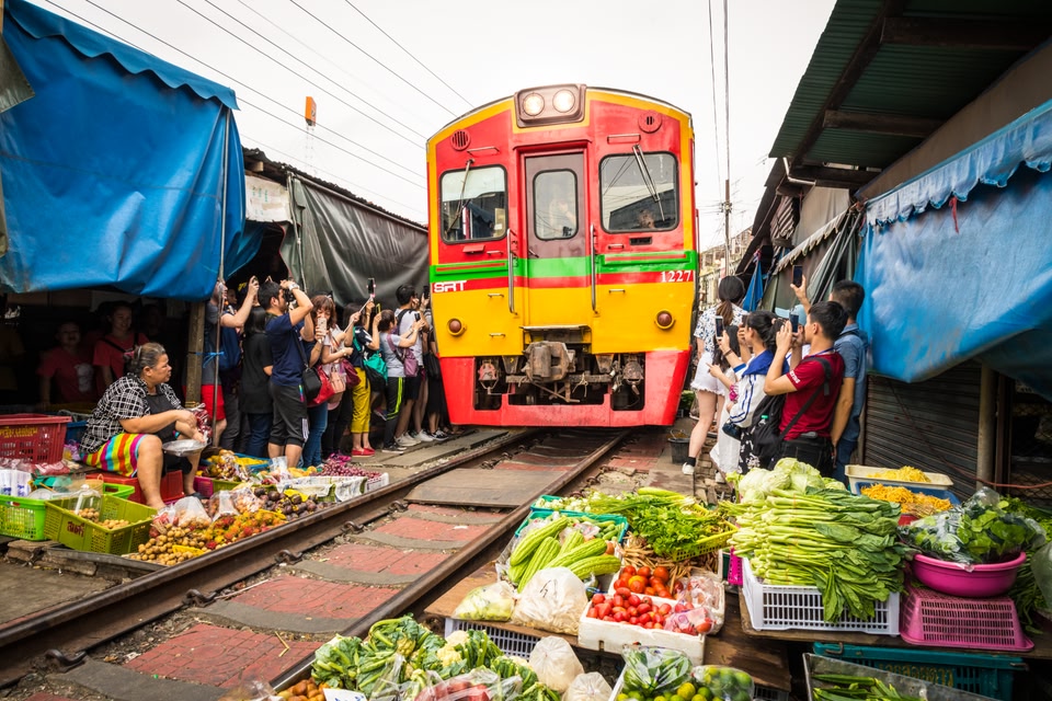 Train running through a vegetable market in Bangkok