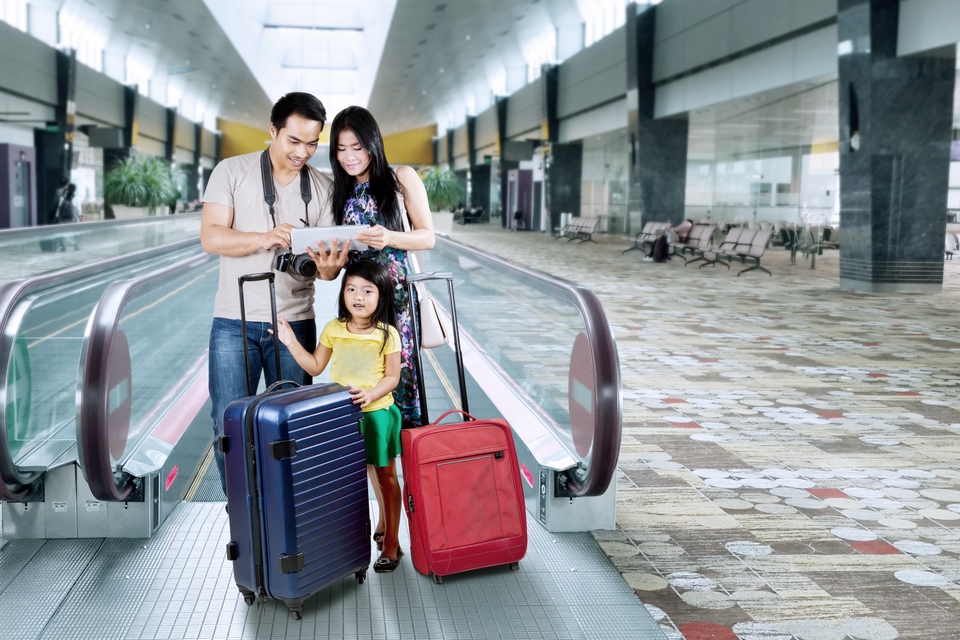 A family looking at a map at the airport