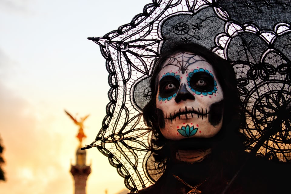 Catrina at the Catrina Parade in Mexico City for Dias de los Muertos. Angel Independence statue lurking in the background.