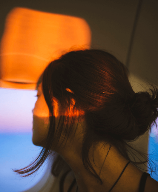 Person looking out of a window on a plane.