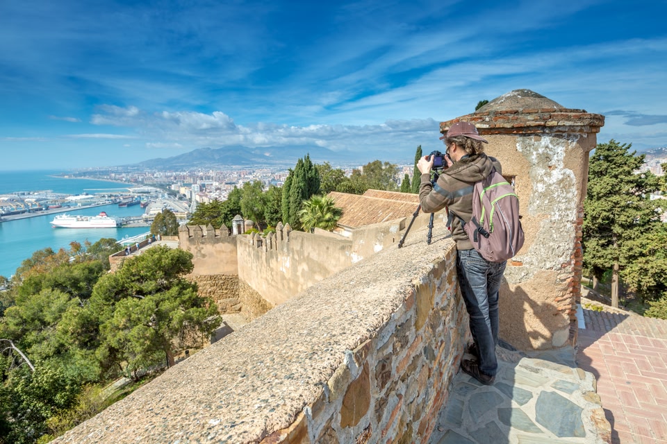 Photographer taking a photo of the sea from Malaga's castle walls.