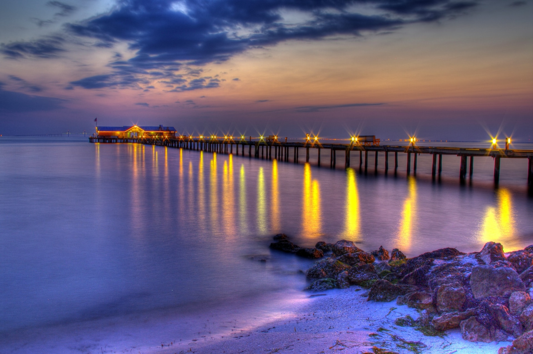 Historic wooden pier at night on Anna Maria Island in Florida.