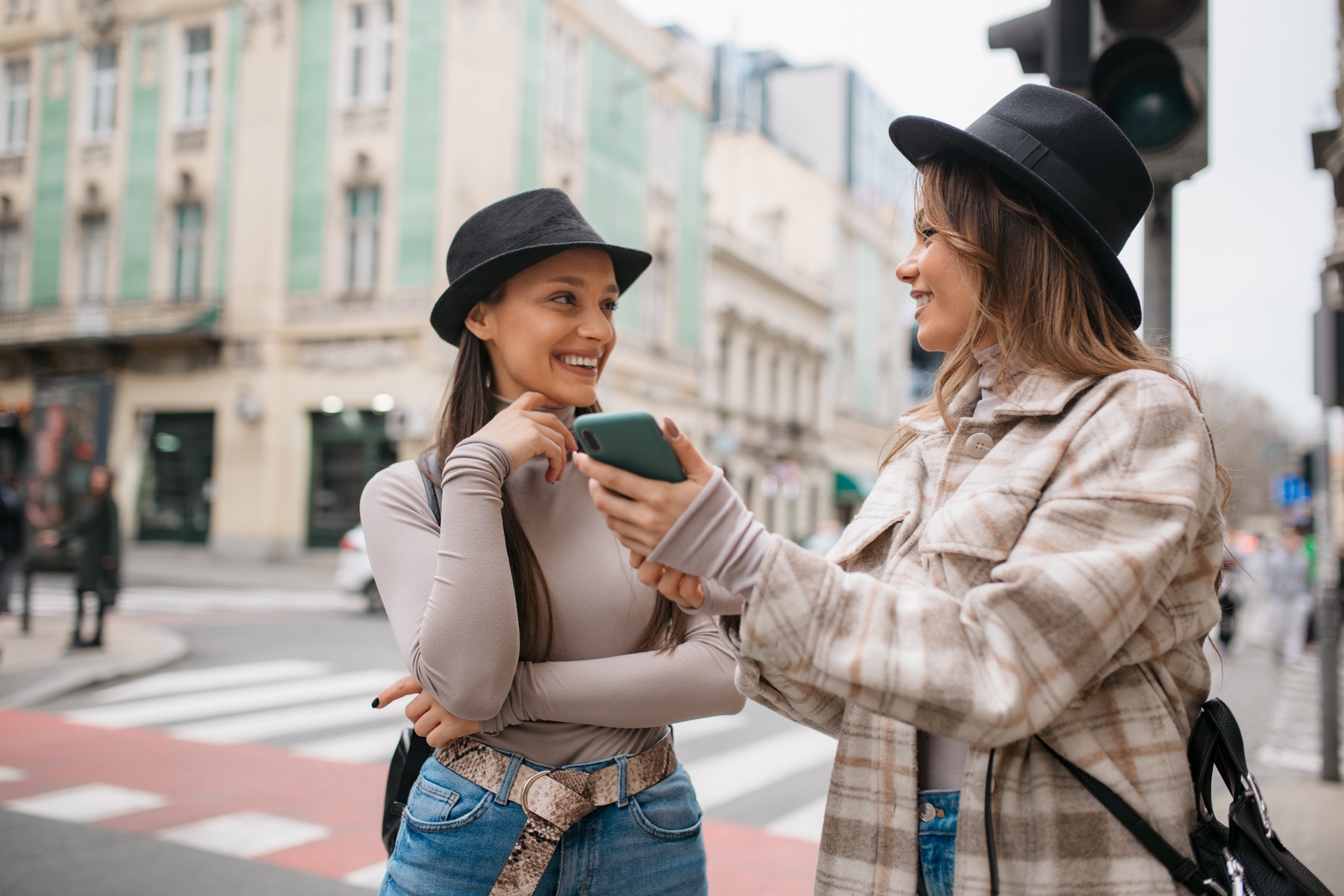 Two women using a travel budget app on a smartphone