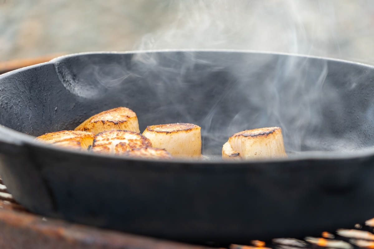 seafood frying in a pan at a beach boil-up in Newfoundland, a must-do travel experience!