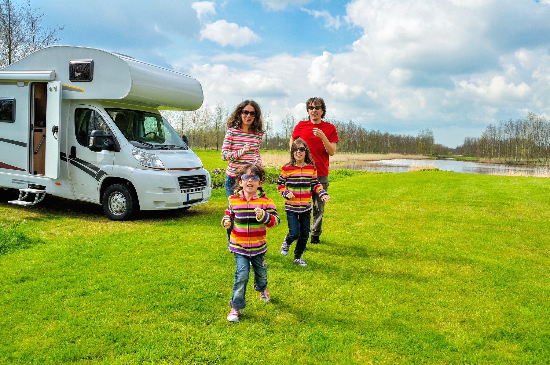 A family of four RV camping outdoors