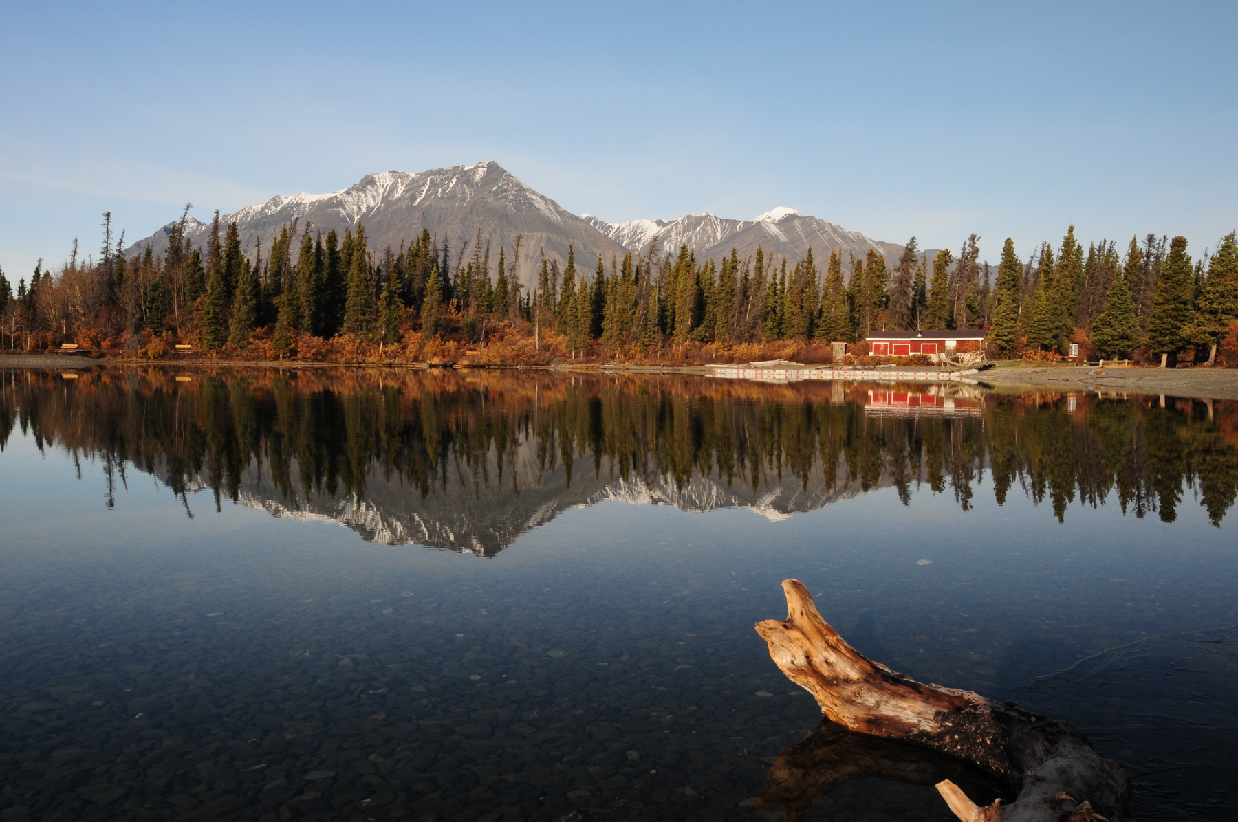 Lake and snow-peaked mountains in the background in Whitehorse, Yukon