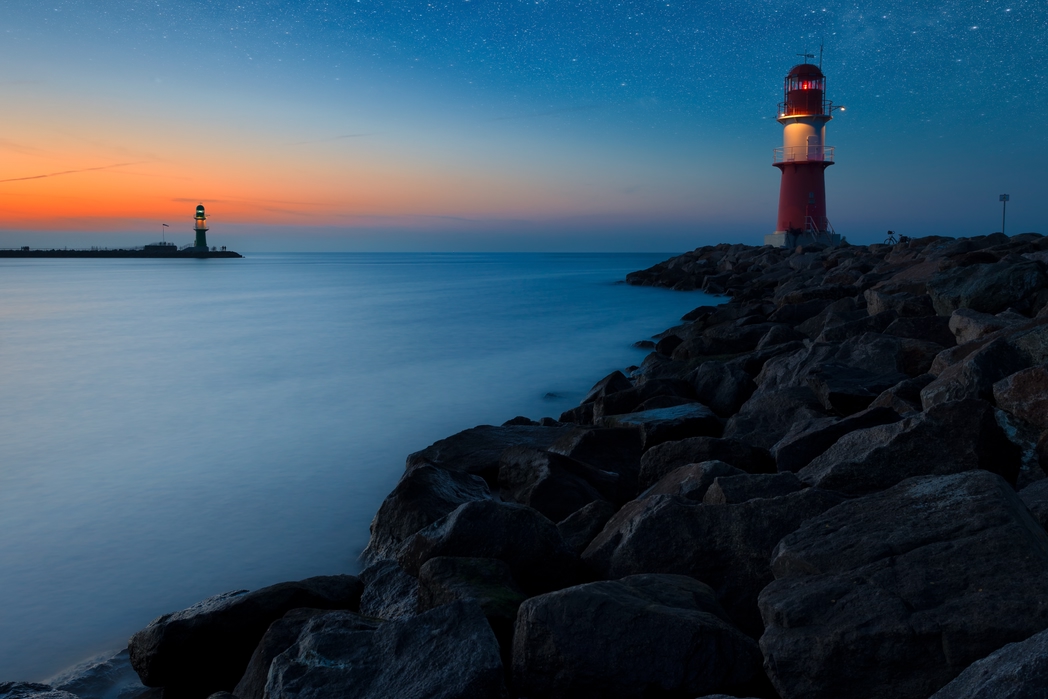 Lighthouse against the rocks in Rostock, Germany