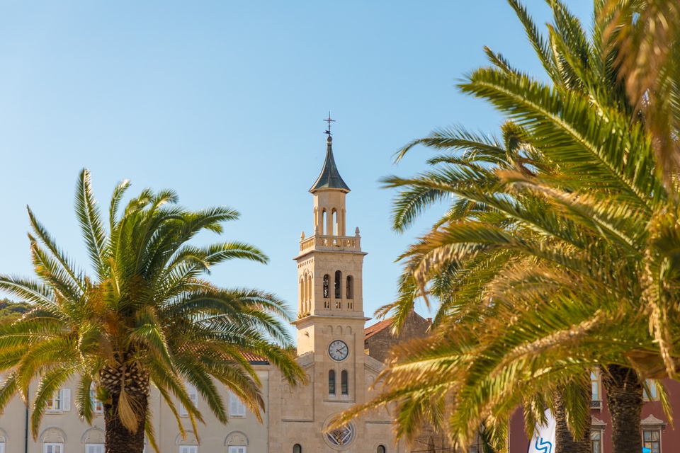 church in Split, Croatia in palm trees out front.