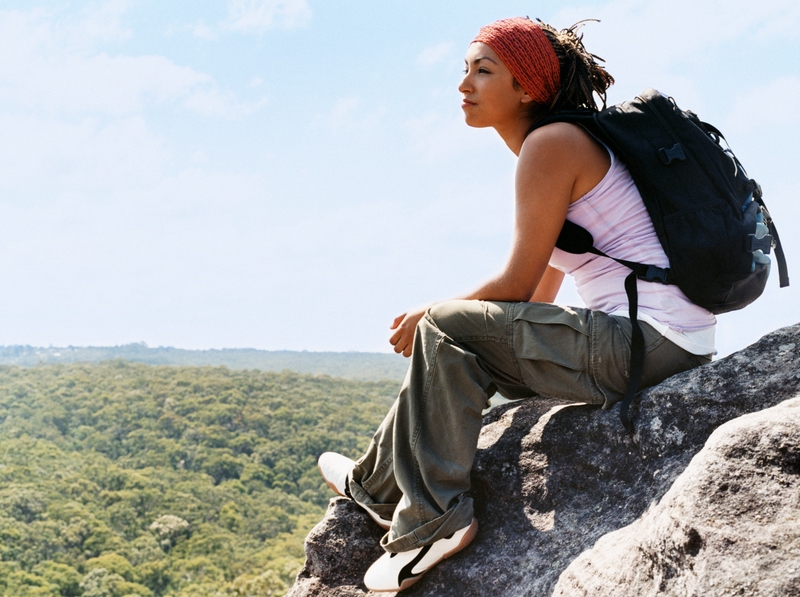 Woman backpacker on a rock