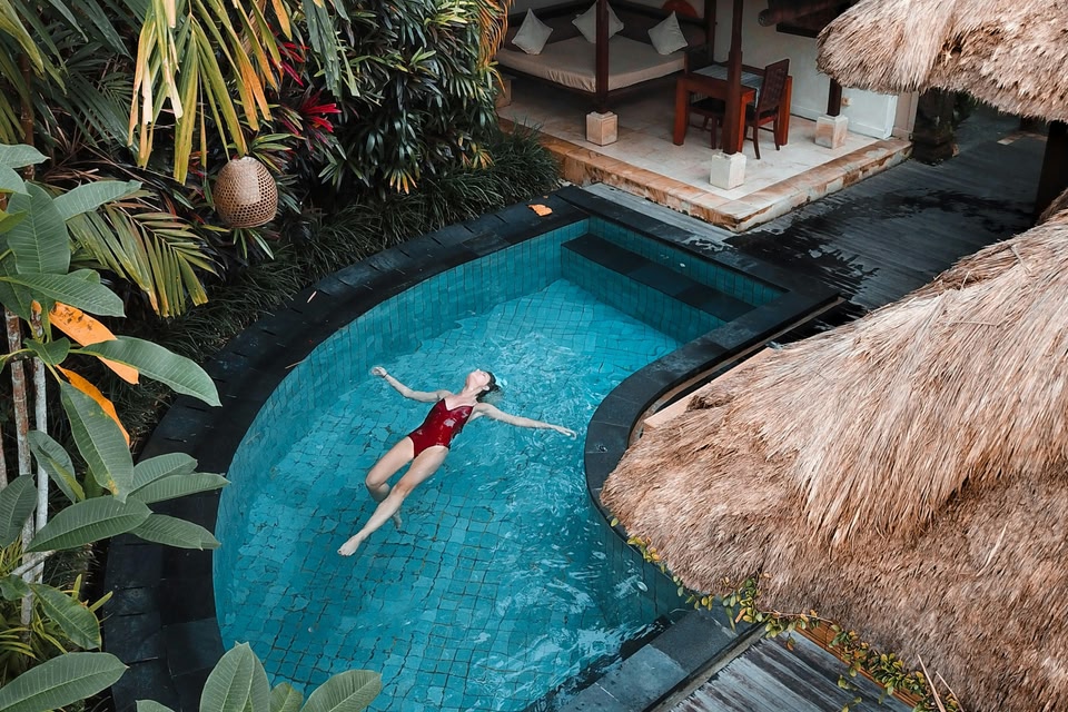 Woman floating in an infinity pool