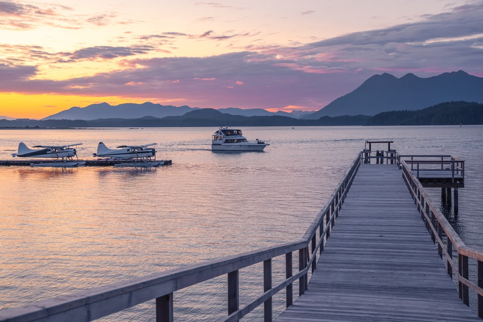 boats at the dock in Tofino at sunset.