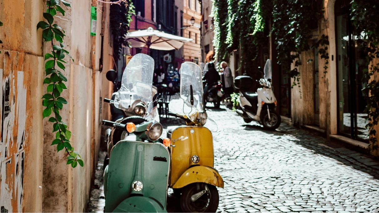 Scooters used for inner-city transport on a cobbled street in Rome during the day