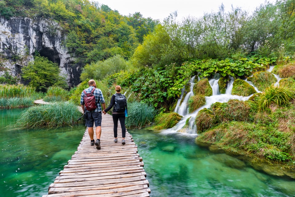 A couple hikes Plitvice Lakes National Park in Croatia.