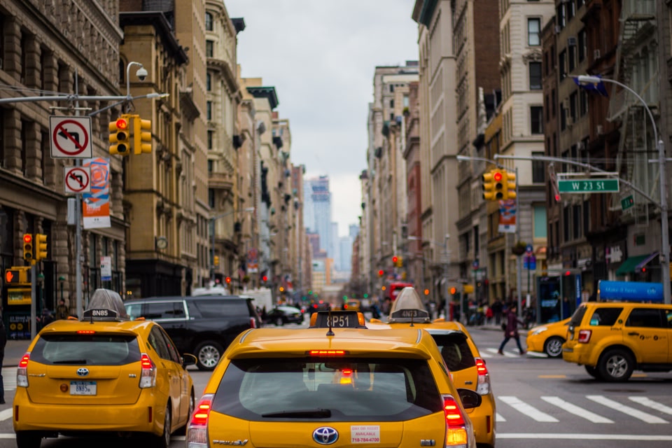 yellow taxis on a busy street in Manhattan, Soho neighbourhood.
