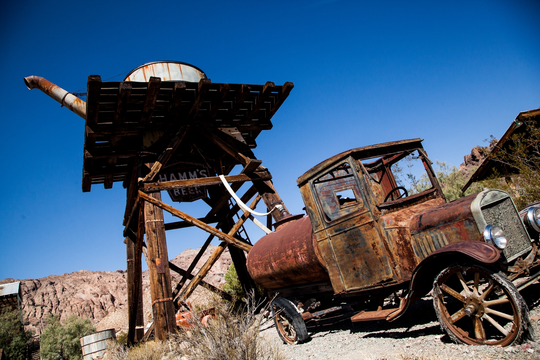 Abandoned water tower and truck at Tehatticup ghost town and mine in Nevada