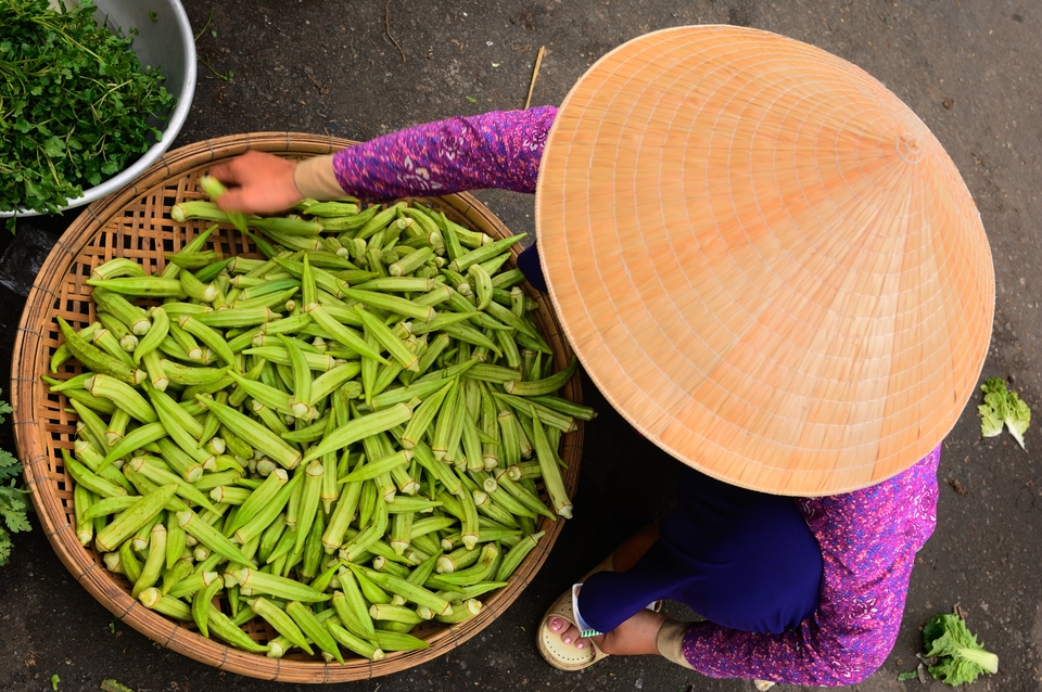A street vendor selling fresh vegetables in Vietnam