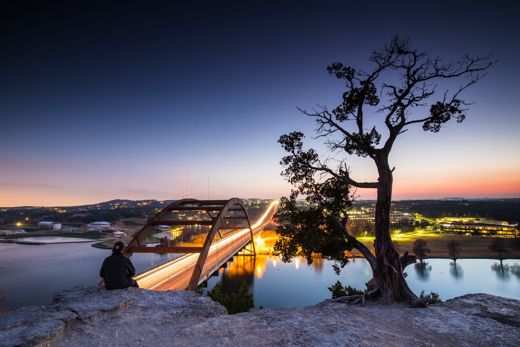 Person sitting over lady birth lake in Austin