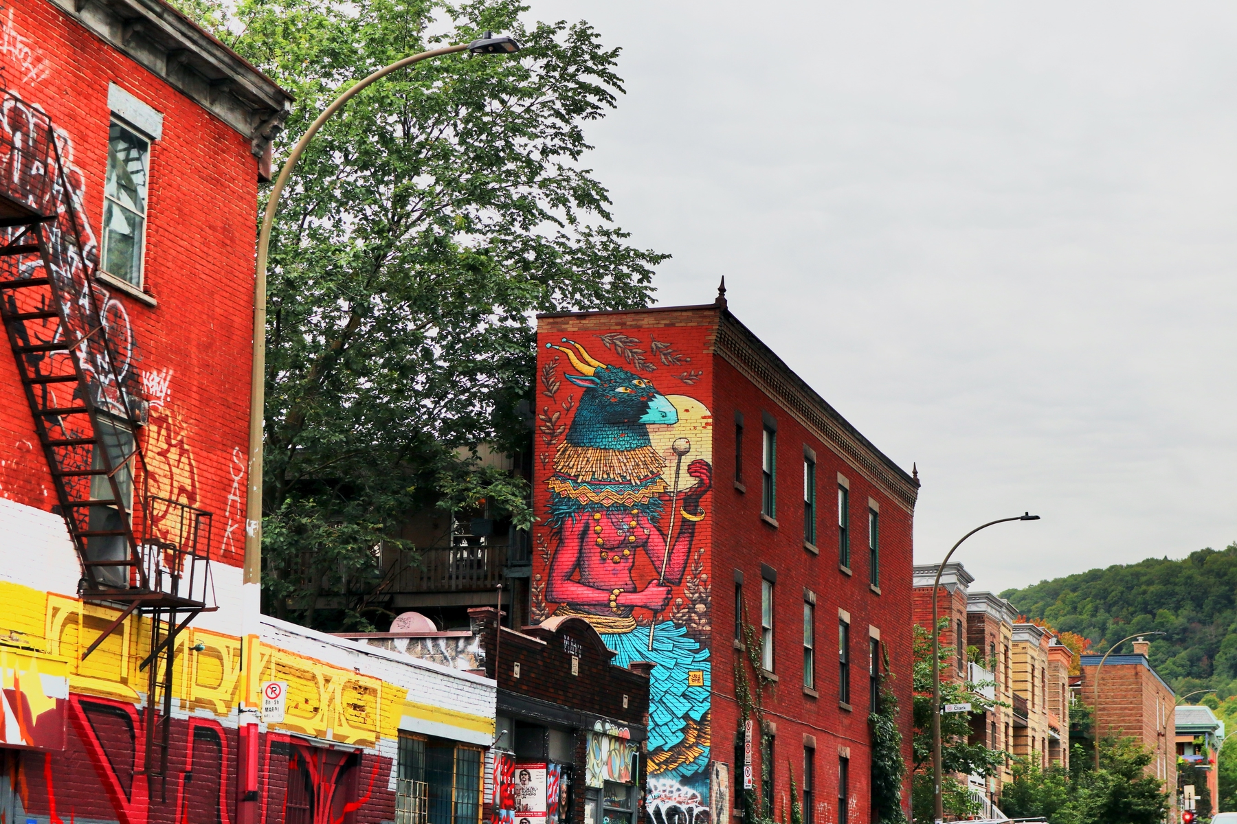 mural art in Montreal's Plateau neighbourhood with Mont Royal in the distance.