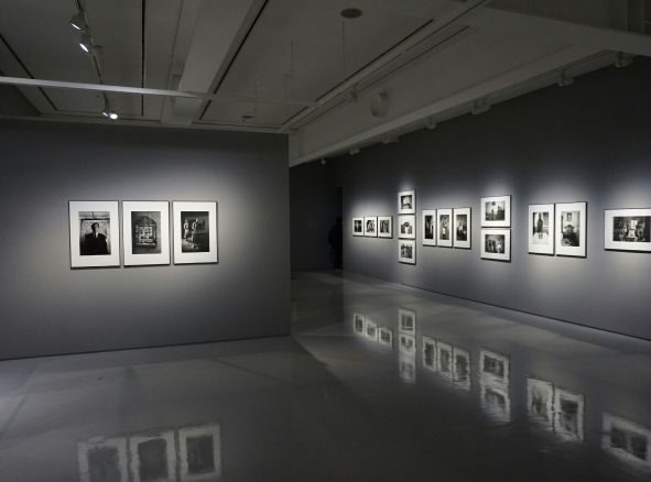 A black and white image of photos on a wall