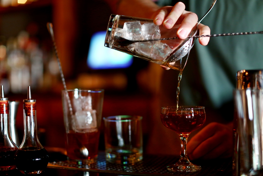 bartender pouring drinks at a bar