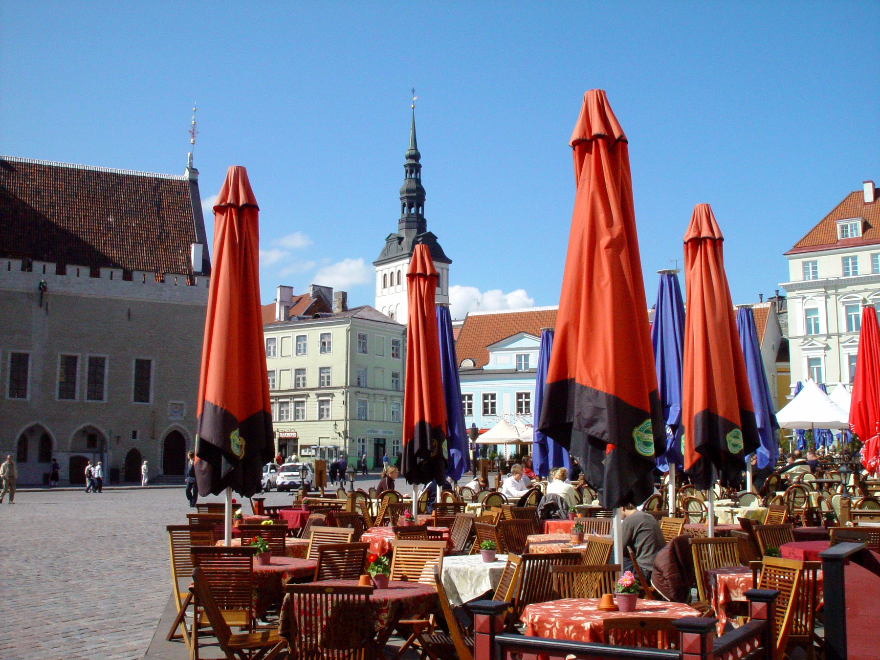tables, chairs, and umbrellas in an Estonian public square